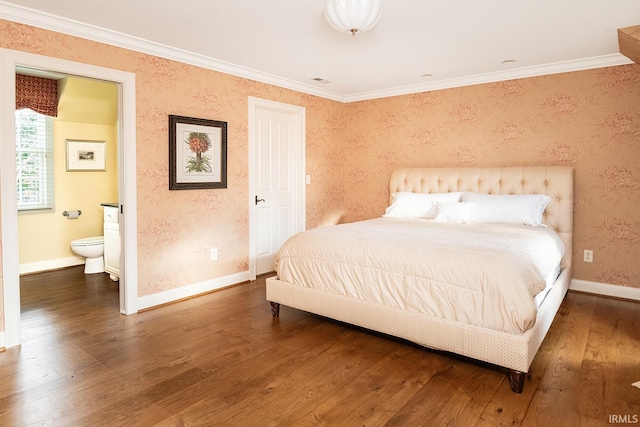 bedroom featuring connected bathroom, dark hardwood / wood-style flooring, and ornamental molding