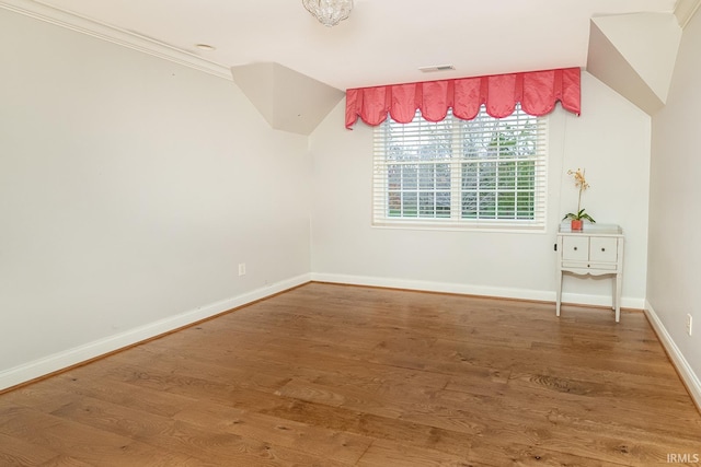 spare room featuring crown molding and hardwood / wood-style flooring