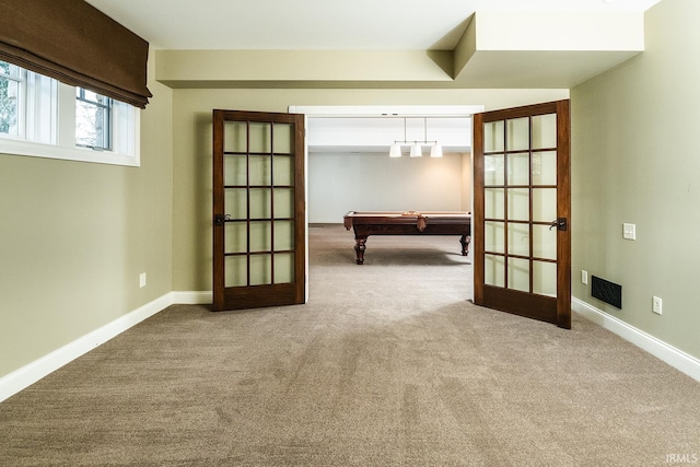 carpeted spare room featuring billiards and french doors