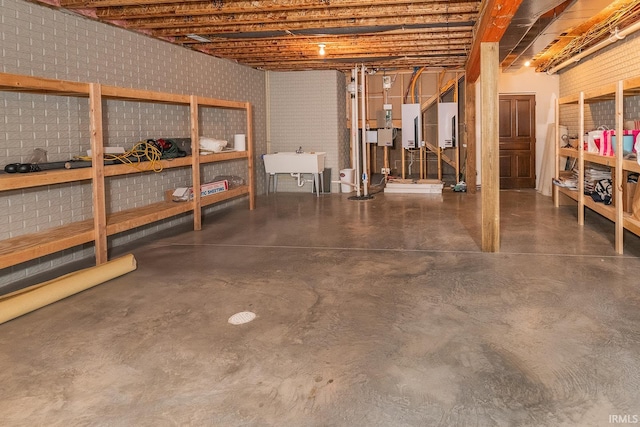 basement featuring electric panel and sink