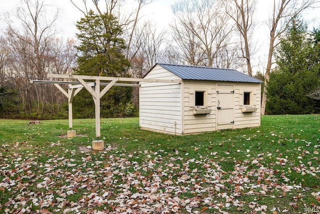 view of outbuilding featuring a lawn