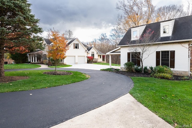 view of front of home with a garage and a front lawn