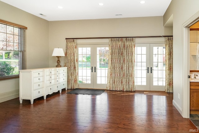 doorway with a healthy amount of sunlight, dark wood-type flooring, and french doors