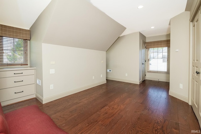 additional living space with dark hardwood / wood-style flooring and lofted ceiling