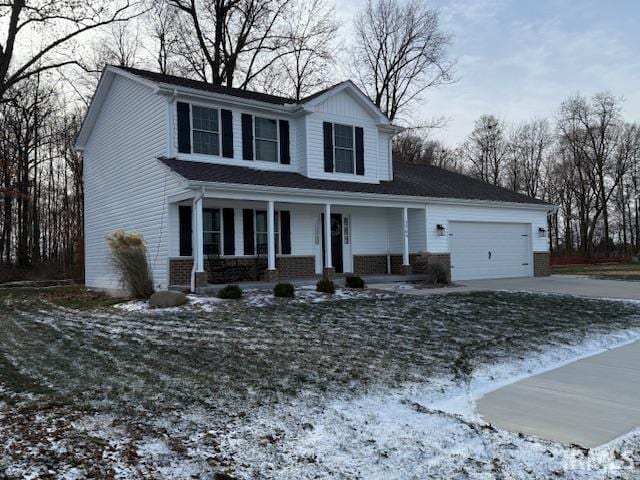 view of front of house featuring covered porch and a garage