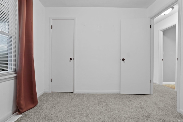 unfurnished bedroom featuring light colored carpet