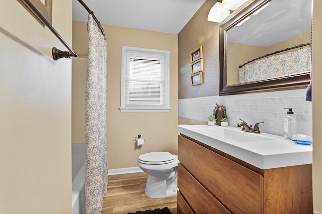 bathroom featuring vanity, toilet, wood-type flooring, and decorative backsplash