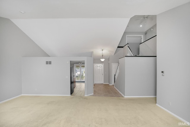 unfurnished living room featuring ceiling fan, lofted ceiling, and light carpet