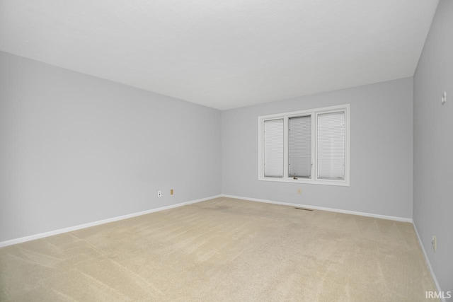 unfurnished room featuring light colored carpet