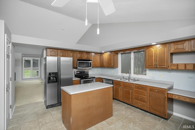 kitchen with stainless steel appliances, sink, light tile patterned floors, a kitchen island, and lofted ceiling