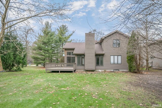 rear view of property with a yard and a deck