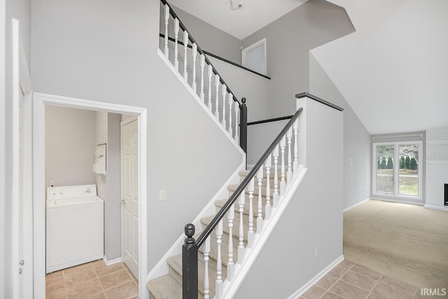 stairs featuring carpet flooring, washer / clothes dryer, and vaulted ceiling