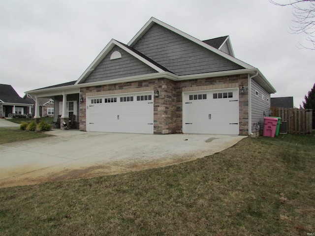 craftsman house featuring a front lawn and a garage