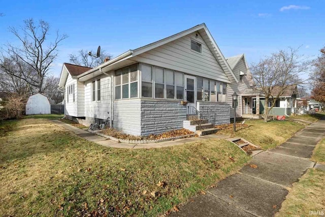 view of front of house featuring a front lawn and a sunroom