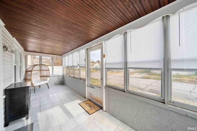 unfurnished sunroom featuring wood ceiling