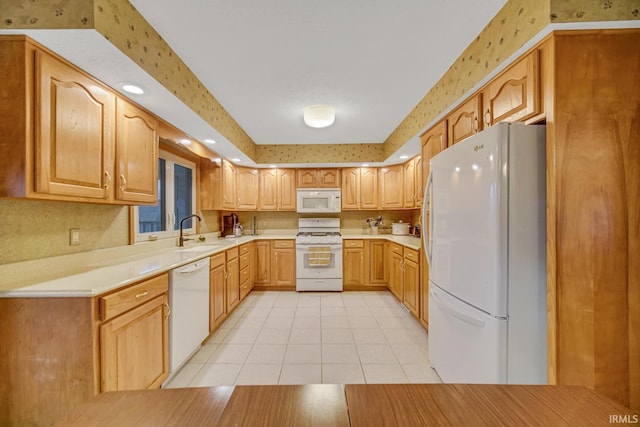 kitchen with sink, light tile patterned floors, and white appliances