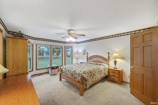 bedroom with ceiling fan and light colored carpet