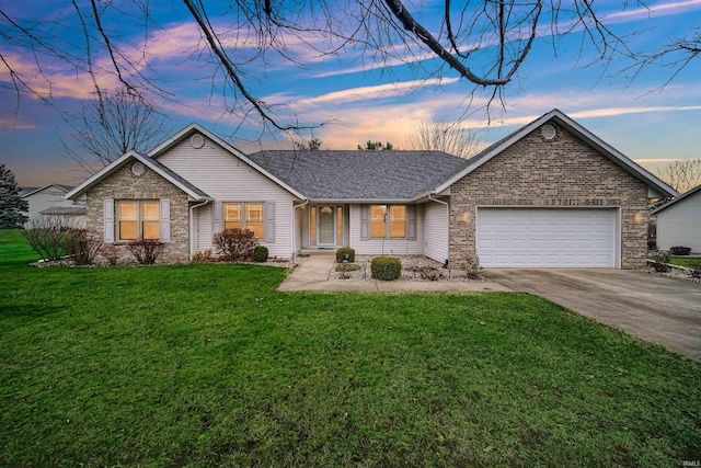 ranch-style house with a yard and a garage