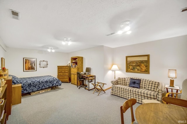 bedroom featuring carpet floors and a textured ceiling