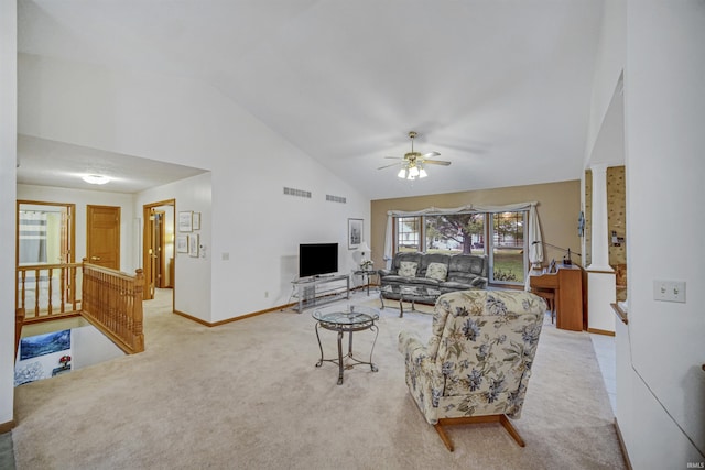 living room with light carpet, high vaulted ceiling, ornate columns, and ceiling fan