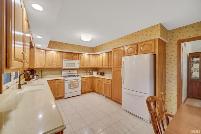 kitchen with white appliances, sink, and light tile patterned floors