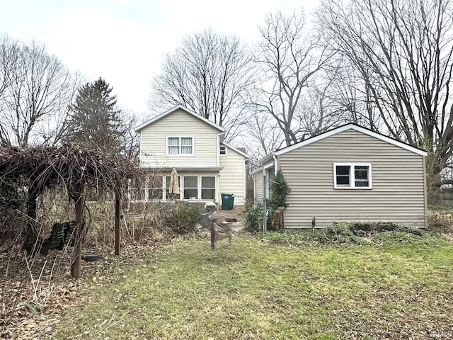 back of property featuring a lawn