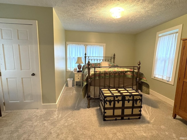 carpeted bedroom with a textured ceiling