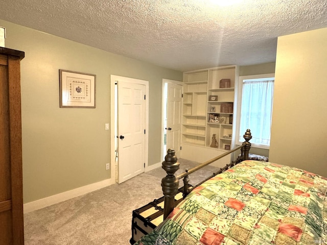 carpeted bedroom featuring a textured ceiling