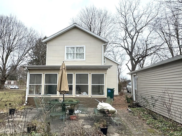 back of property with a sunroom