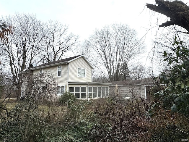 back of house with a sunroom