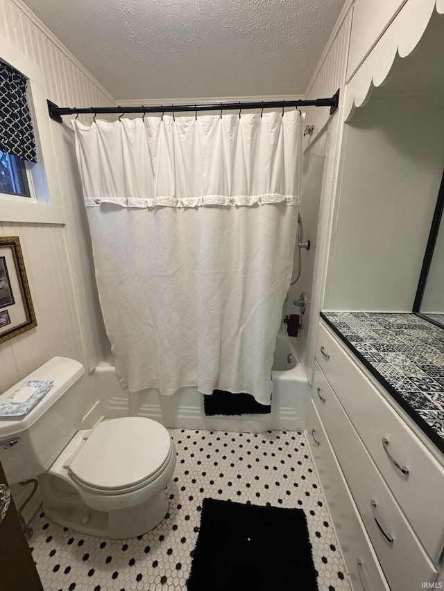 full bathroom featuring vanity, tile patterned floors, toilet, a textured ceiling, and shower / tub combo