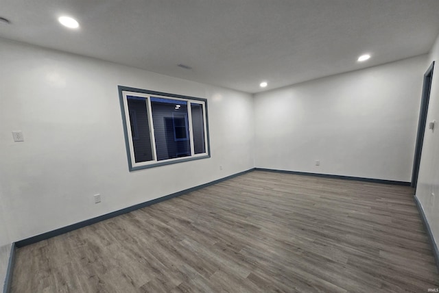 unfurnished room featuring dark hardwood / wood-style flooring