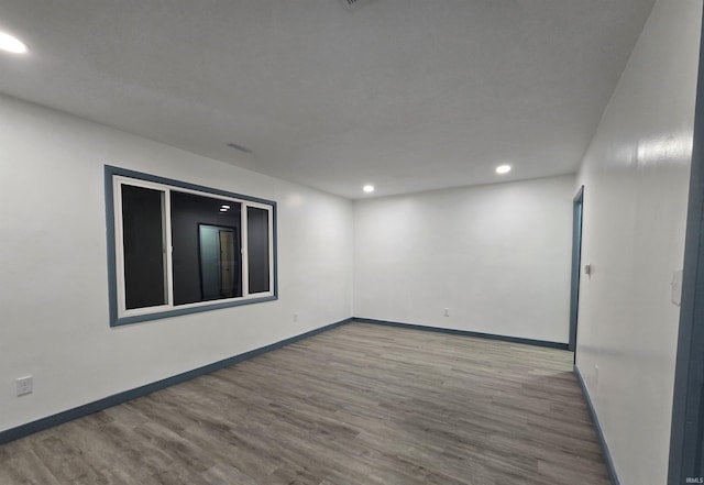 empty room with wood-type flooring