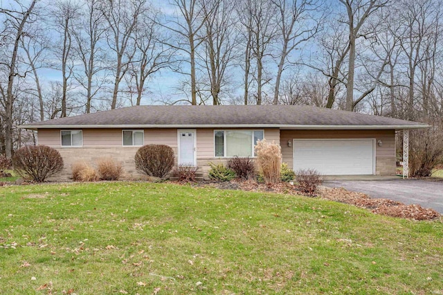 ranch-style home with a garage and a front yard