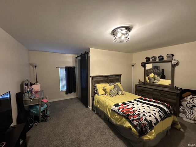 bedroom featuring dark carpet and a barn door