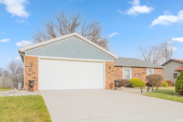 view of front of property with a garage and central AC