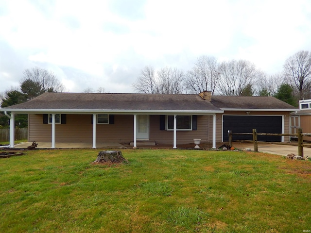 view of front of house featuring covered porch, a front yard, and a garage