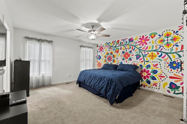 bedroom featuring carpet, a textured ceiling, and ceiling fan