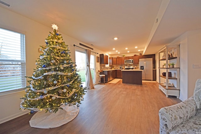 living room featuring a wealth of natural light and light hardwood / wood-style flooring