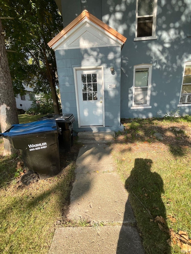 view of exterior entry featuring a yard