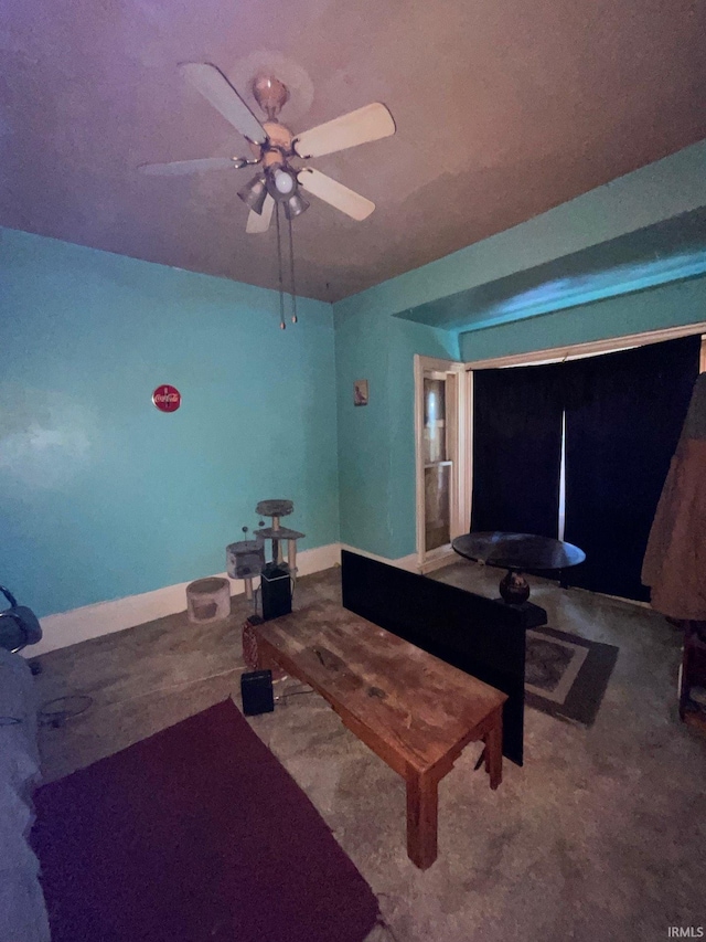 carpeted living room with ceiling fan