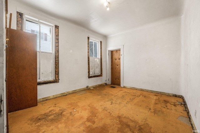 empty room with concrete flooring