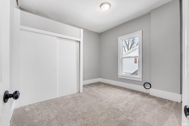 unfurnished bedroom featuring carpet floors and a closet