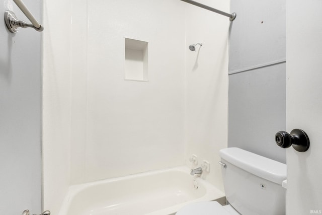 bathroom with toilet and  shower combination