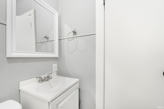 bathroom with toilet and vanity