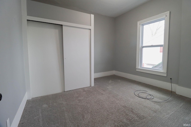 unfurnished bedroom featuring a closet and carpet flooring