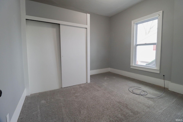 unfurnished bedroom featuring a closet and carpet floors