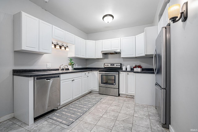 kitchen with light tile patterned floors, white cabinetry, sink, and appliances with stainless steel finishes