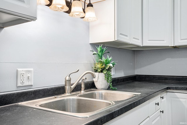 kitchen with white cabinets, a notable chandelier, sink, and hanging light fixtures