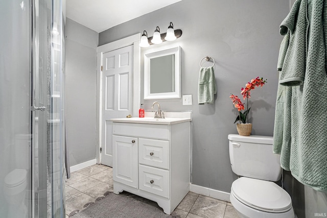 bathroom featuring tile patterned floors, a shower, vanity, and toilet